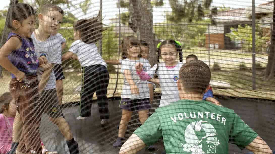 Projects Abroad volunteer works with the children in Costa Rica as part of his Childcare placement Childacre volunteer plays a game on the trampoline with the children in Costa Rica.